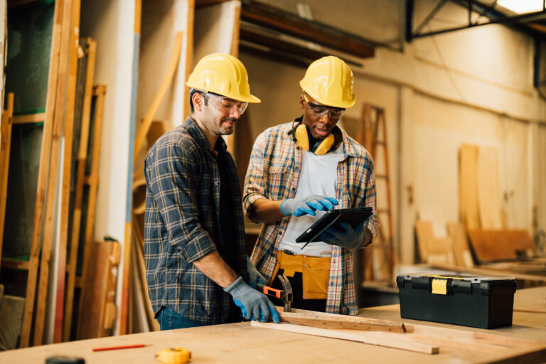Two Carpenter working on wood craft at workshop
